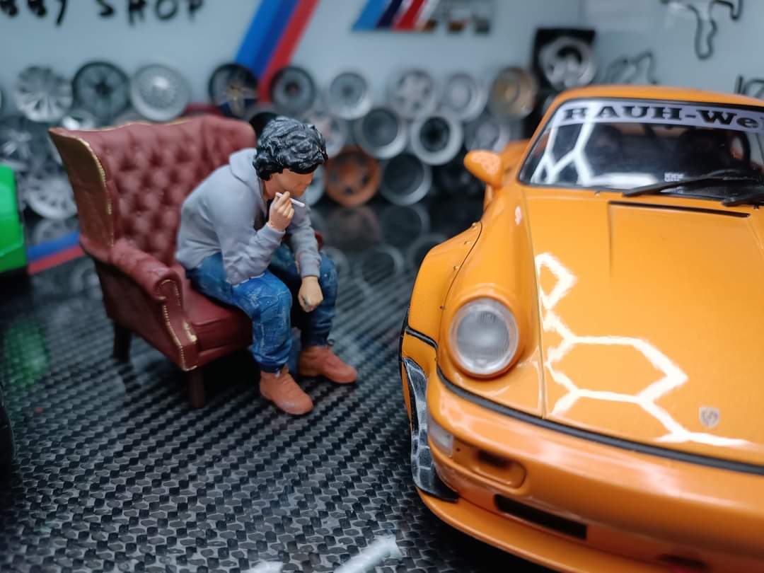Akira Nakai-San figure smoking and sitting in chair