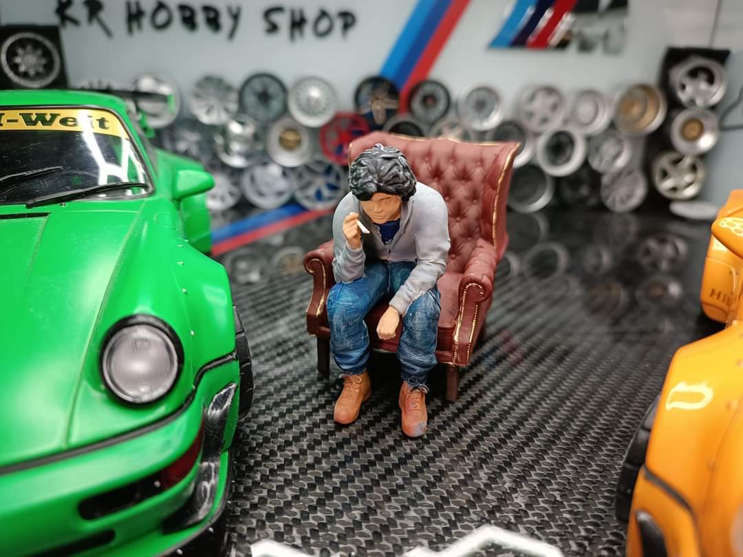 Akira Nakai-San figure smoking and sitting in chair